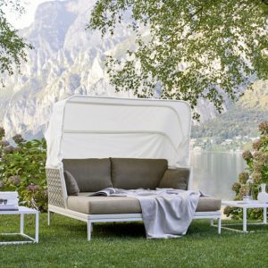 Loom Crafts Outdoor Garden Furniture A daybed on a grassy area with a view of a lake.