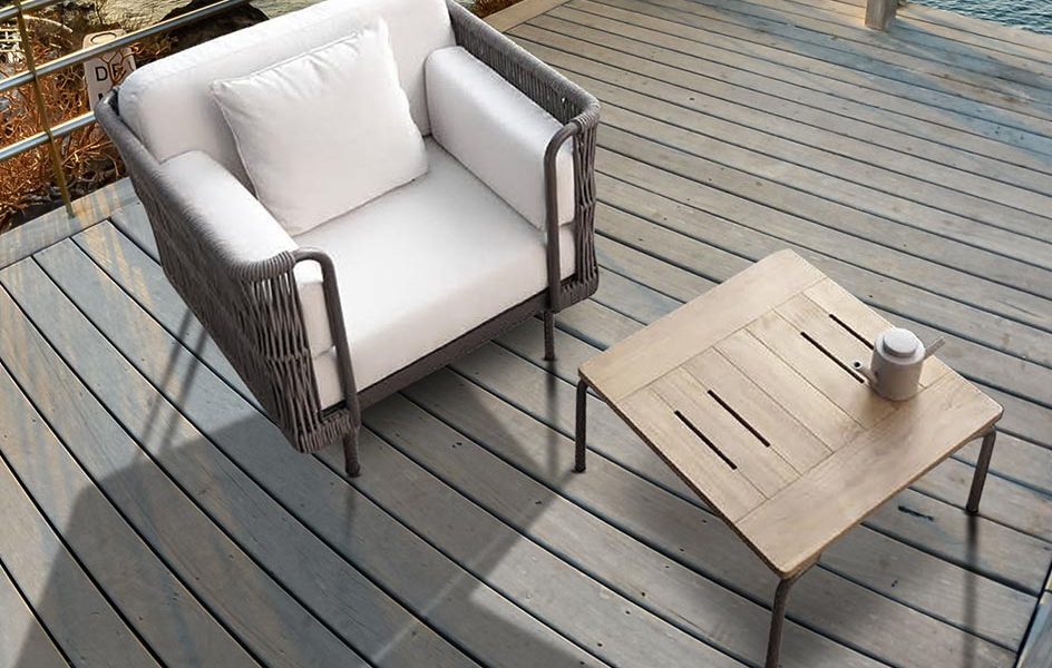 Loom Crafts Outdoor Garden Furniture A white wicker chair and table on a wooden deck.