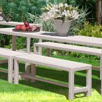 Loom Crafts Outdoor Garden Furniture A white bench and table in a grassy area.
