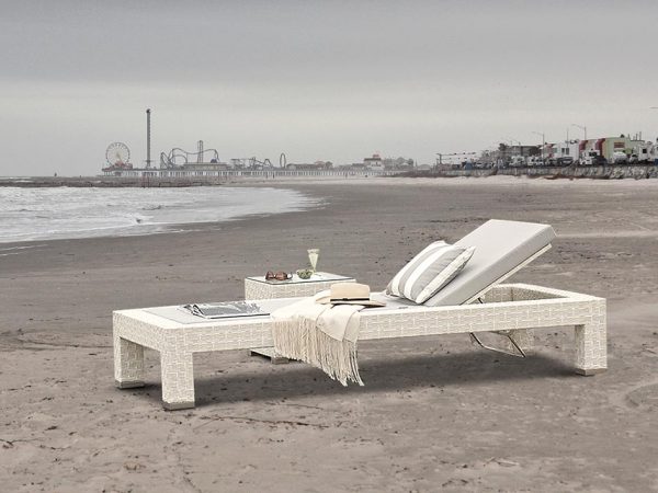 Loom Crafts Outdoor Garden Furniture A white wicker chaise lounge on the beach.