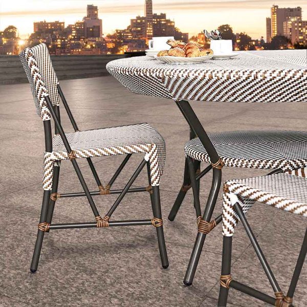 Loom Crafts Outdoor Garden Furniture A table and chairs on a rooftop with a view of the city.