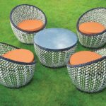 Loom Crafts Outdoor Garden Furniture Four LOUNGE CHAIRS WITH CUSHION (LCOD/300/001) and a table on the grass.
