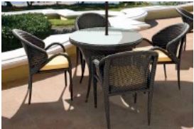 Loom Crafts Outdoor Garden Furniture A wicker DINING TABLE WITH GLASS TOP (LCOD/143/002) and chairs with umbrella.