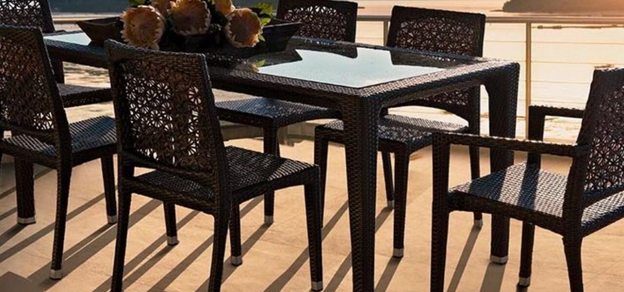 Loom Crafts Outdoor Garden Furniture An outdoor dining table with a view of the ocean.