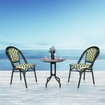 Loom Crafts Outdoor Garden Furniture Two MAGNA LCCH.003.001 and a table on a wooden deck with a view of the ocean.
