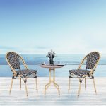 Loom Crafts Outdoor Garden Furniture Two TIFFANY LCCH.004.004 and a table on a wooden deck overlooking the ocean.