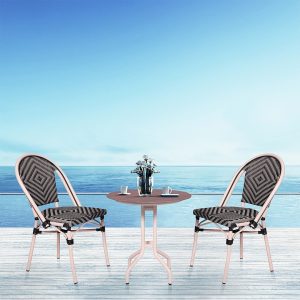 Loom Crafts Outdoor Garden Furniture Two AUDREY LCCH.005.001s and a table on a deck overlooking the ocean.