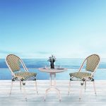 Loom Crafts Outdoor Garden Furniture Two AUDREY LCCH.005.002 and a table on a deck overlooking the ocean.