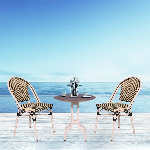 Loom Crafts Outdoor Garden Furniture Two AUDREY LCCH.005.003 and a table on a deck overlooking the ocean.