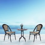 Loom Crafts Outdoor Garden Furniture Two MAGNA LCCH.003.003 and a table on a deck overlooking the ocean.