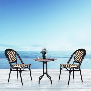 Loom Crafts Outdoor Garden Furniture Two MAGNA LCCH.003.003 and a table on a deck overlooking the ocean.