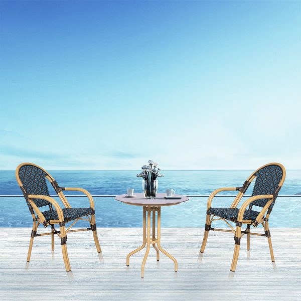 Loom Crafts Outdoor Garden Furniture Two MARILYN LCCH.006.003s and a table on a deck with a view of the ocean.