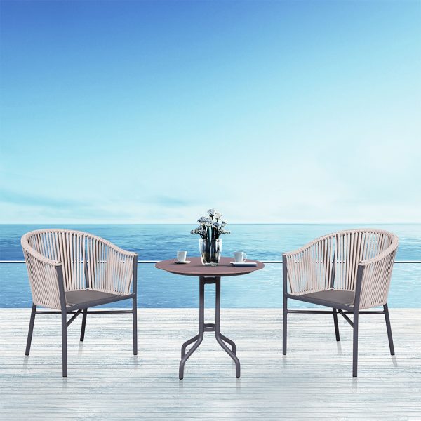 Loom Crafts Outdoor Garden Furniture Two MONTANA LCCH.007.001 and a table on a wooden deck with a view of the ocean.
