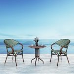 Loom Crafts Outdoor Garden Furniture Two FUTANI LCCH.002.002 and a table on a wooden deck with a view of the ocean.