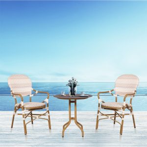 Loom Crafts Outdoor Garden Furniture Two BRITTANY LCCH.009.001 and a table on a wooden deck with a view of the ocean.