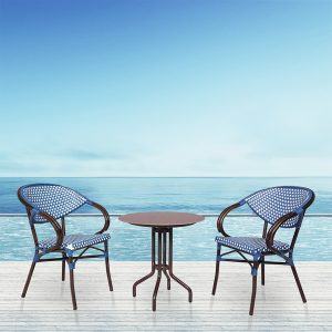 Loom Crafts Outdoor Garden Furniture Two FUTANI LCCH.002.003 and a table on a balcony overlooking the ocean.