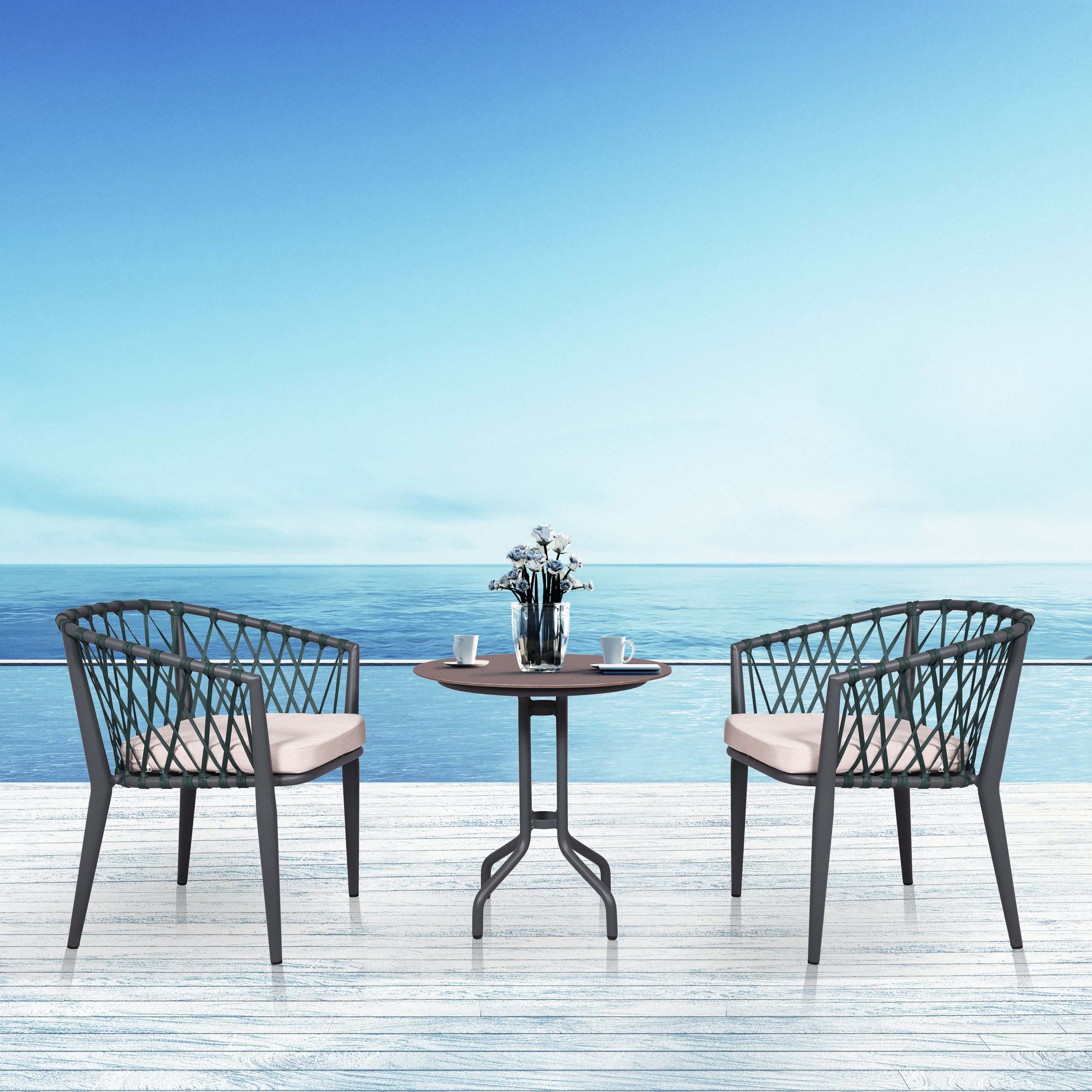 Loom Crafts Outdoor Garden Furniture Two LEO LCCH.010.004 and a table on a deck overlooking the ocean.