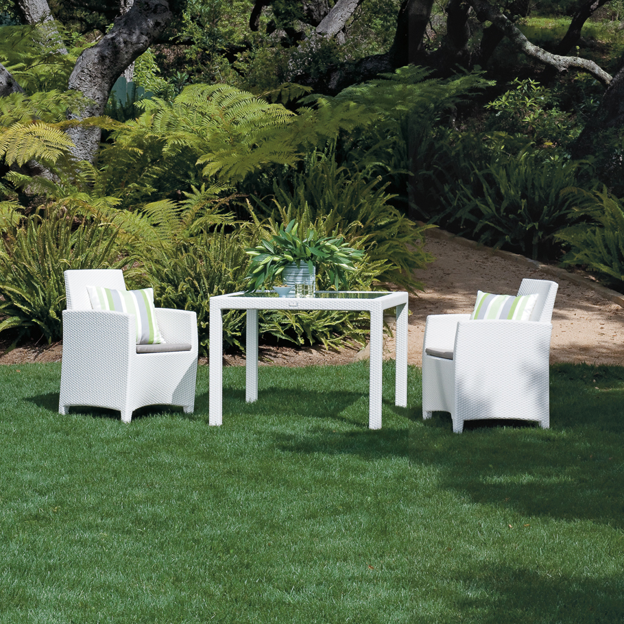 Loom Crafts Outdoor Garden Furniture A white table and chairs in a grassy area.