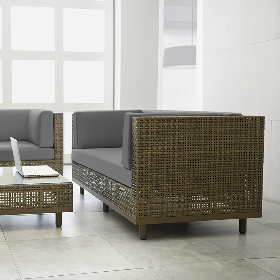 Loom Crafts Outdoor Garden Furniture A living room with wicker furniture and a coffee table.