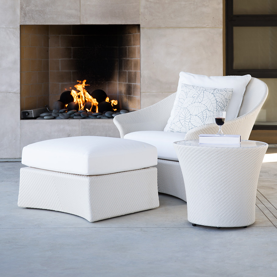 Loom Crafts Outdoor Garden Furniture A white wicker chair and ottoman in front of a fireplace.