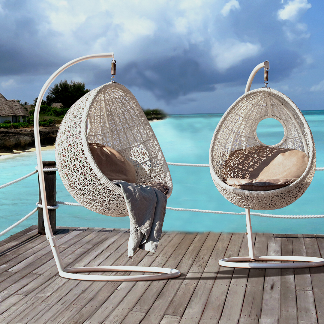 Loom Crafts Outdoor Garden Furniture Two rattan hanging chairs on a wooden deck.