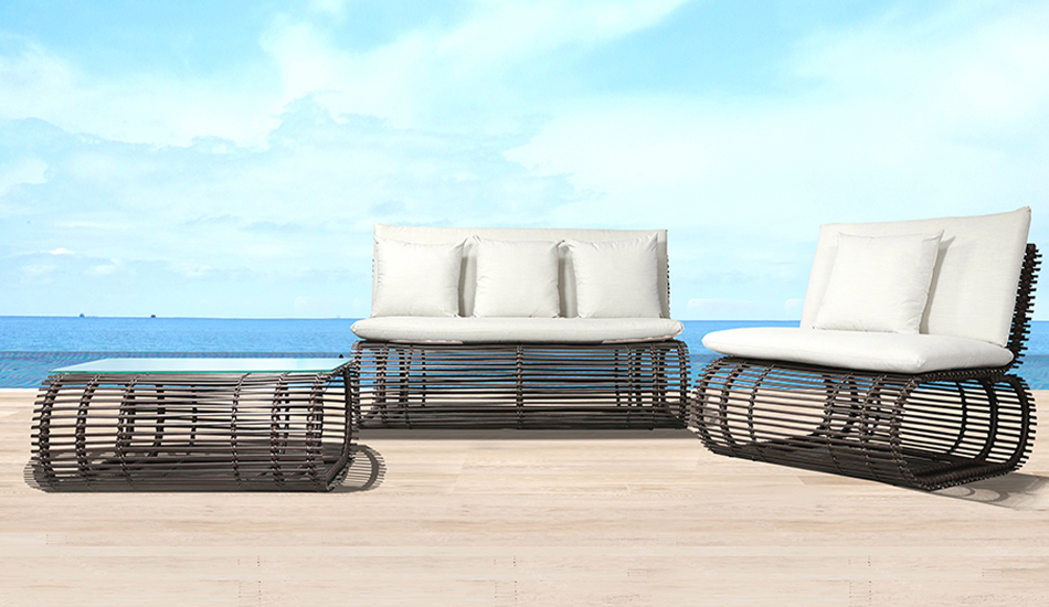 Loom Crafts Outdoor Garden Furniture A set of outdoor furniture on a wooden deck with a view of the ocean.
