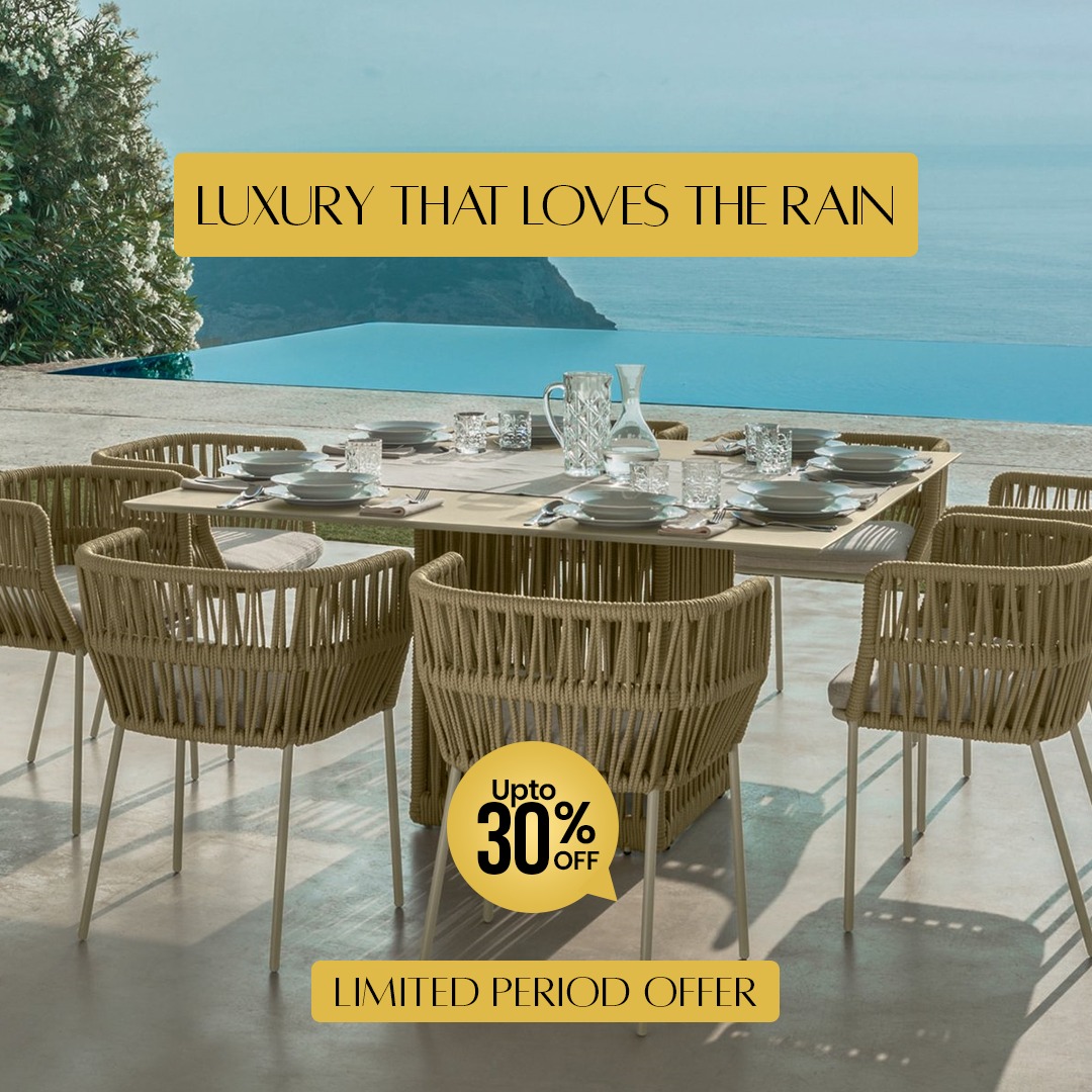 Loom Crafts Outdoor Garden Furniture A modern outdoor daybed with wicker detailing is positioned near the ocean shore on a wooden deck, accompanied by text overlay stating "LIFE TIME WARRANTY".